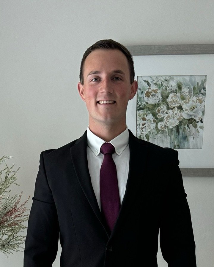 Eoghan, founder of effectiveclick, smiling in a dark suit and tie
