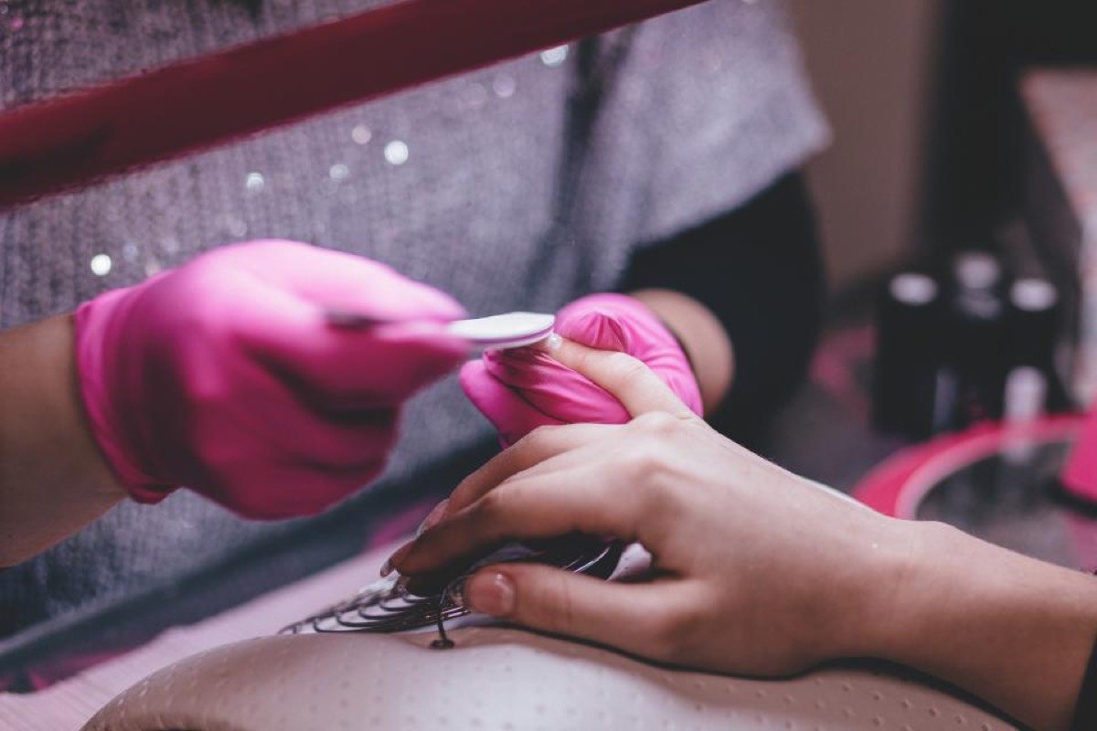 A nail technician giving a manicure